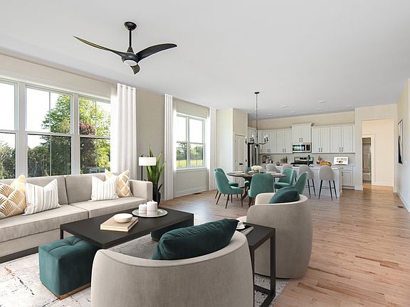 Spacious modern living room with large windows, a sectional sofa, and an open plan layout including