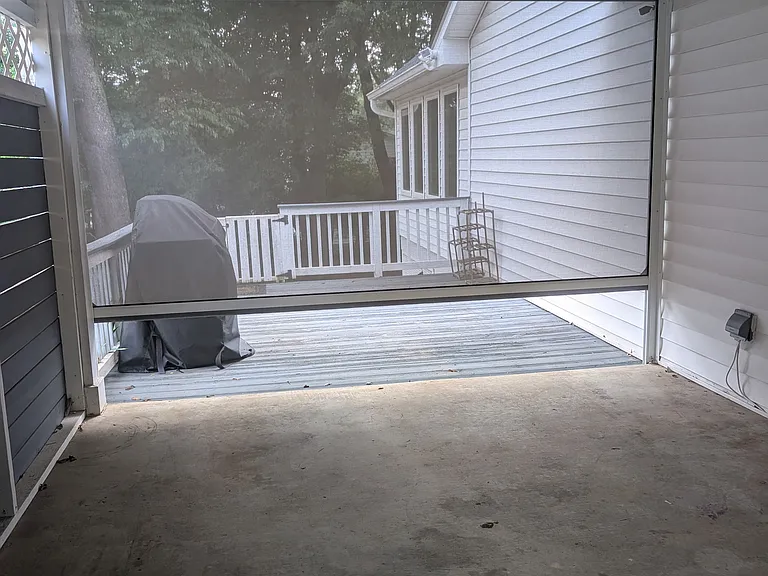 Carport with motorized privacy screen, a grill that is hooked up to gas line.