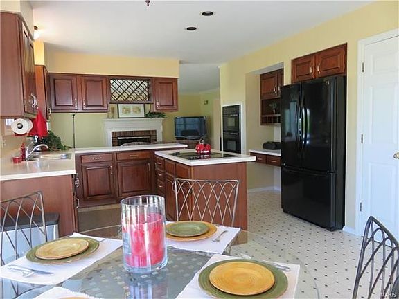 Kitchen offers ample light cherry stained cabinets, breakfast bar with lots of extra storage, planning desk or modern coffee bar, bayed breakfast area, refrigerator stays!