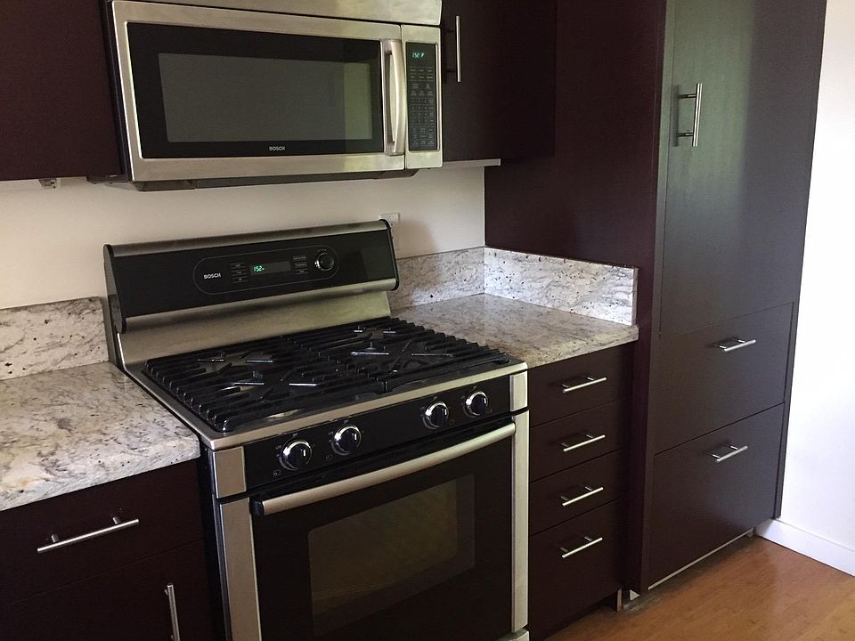 Kitchen with built in SubZero refrigerator, gas cooktop, electric oven, microwave