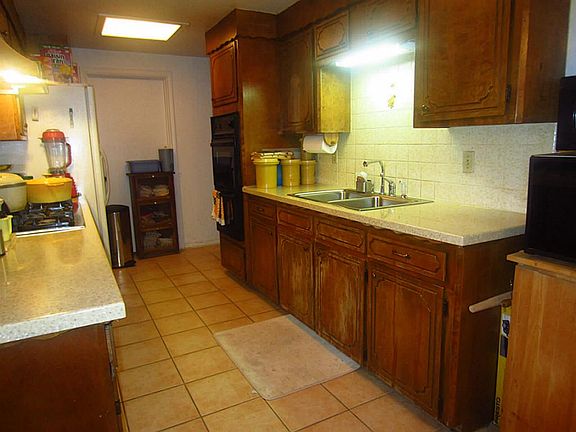 Plenty of counters in kitchen and tile floors.