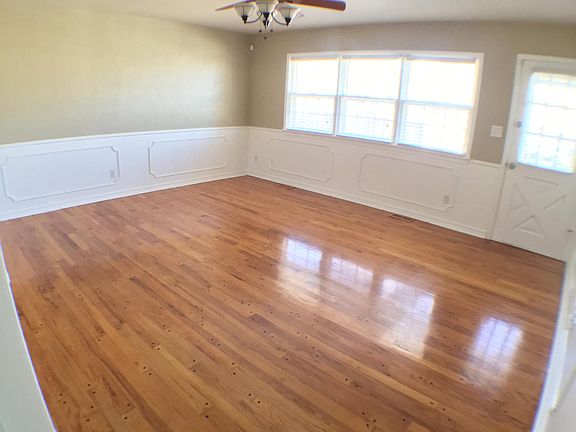 Living room has gorgeous hardwoods and tons of natural light.