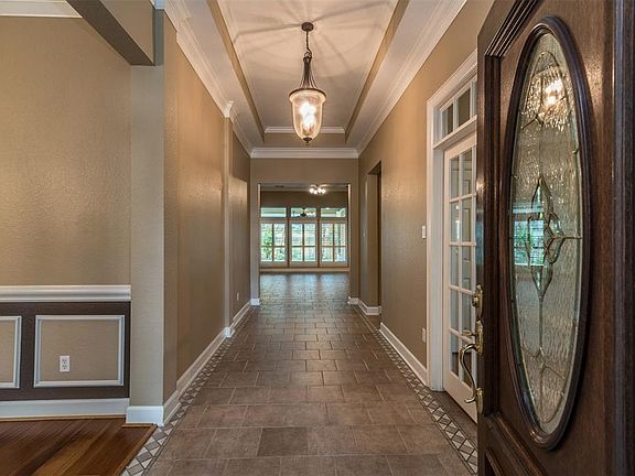 Welcome. Formal dining on left, French doors at right open to a spacious study. Both have wood flooring.