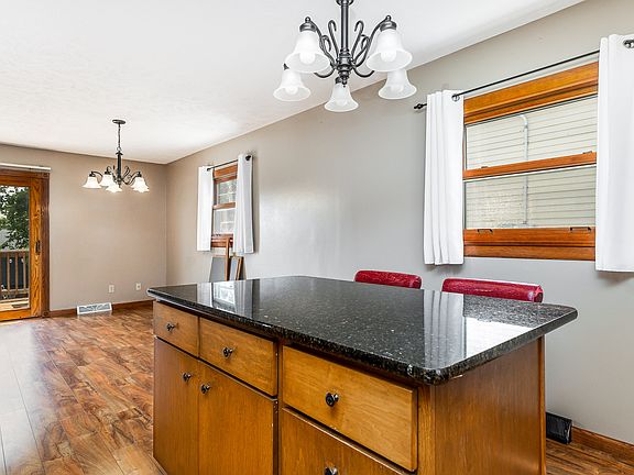 Kitchen attaches to dining area and leads out to patio for easy outdoor meals! Grill on patio included.