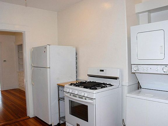 kitchen. washer and dryer in unit - looking into the full dining room.