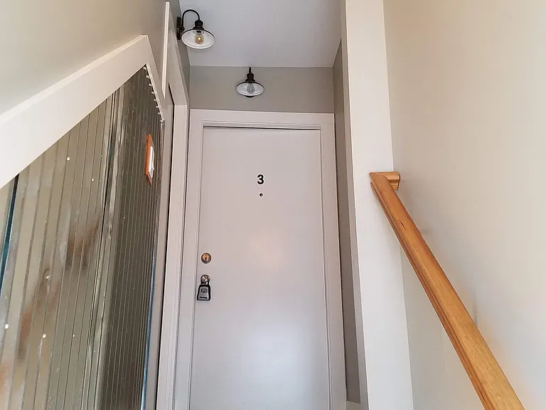 Apartment 3 door at the top of the stairs. This is a 2nd floor apartment.