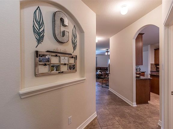 When you enter through the front door you are met with an art niche and tiled floors.