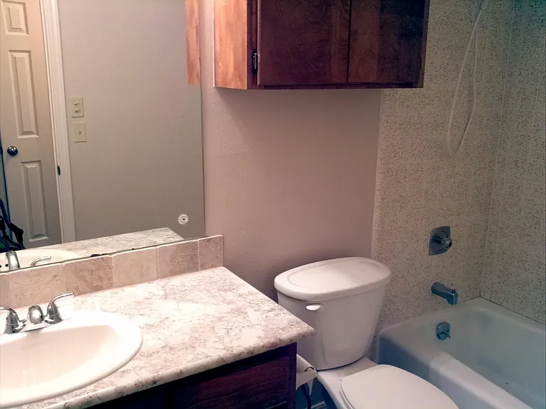 MAIN BATH, A FEW STEPS FROM THE KITCHEN AND ACCROSS HALL TO THE BEDROOMS.