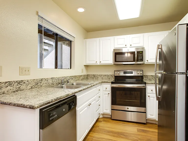 Kitchen with spacious granite countertops and stainless steel appliances
