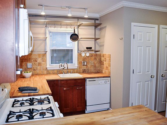 Kitchen, with view to pantry area and laundry closet