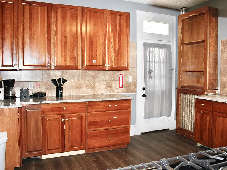 Large kitchen with numbered cabinets to storage each members items.