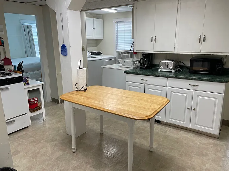 Kitchen with laundry area and downstairs bedroom