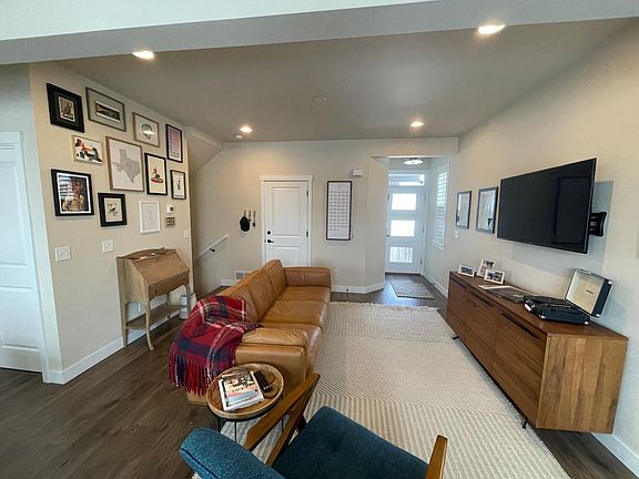 Living space showing front door, door to garage, and stairwell to basement.