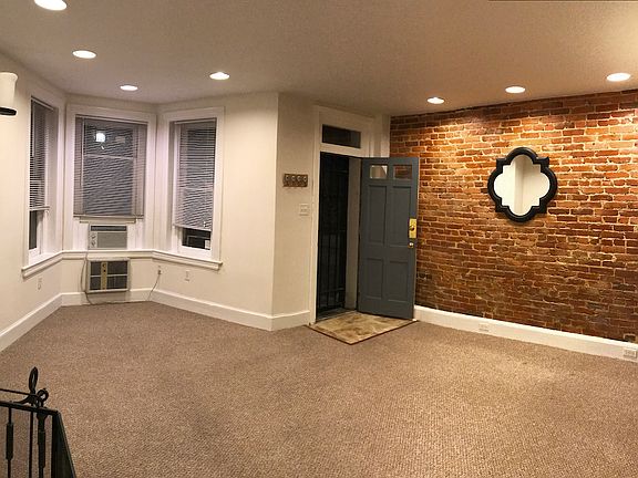 Living Room highlighting exposed brick wall
