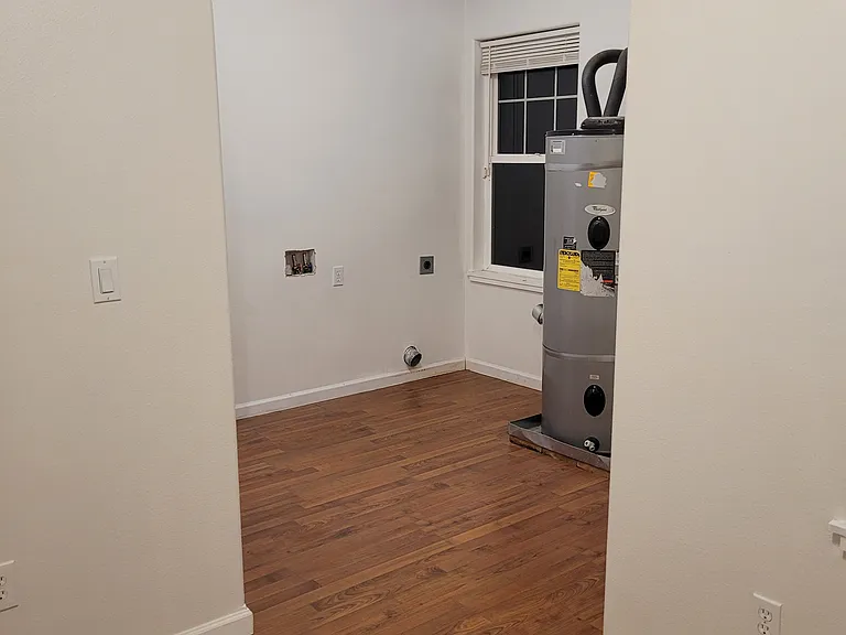 Further down the hall is the laundry room. This is looking back at the washer/dryer hookup (washer/dryer not included). There is additional space in laundry room that could be used as office or play room.