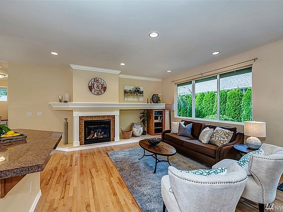 The living room has a gas fireplace and beautiful mill work that includes space for your TV.