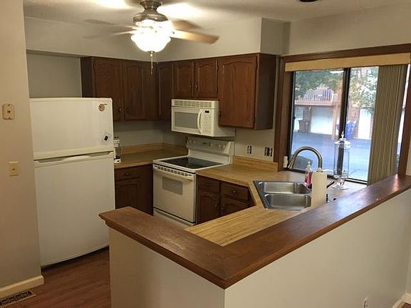 Kitchen includes microwave, dishwasher, refrigerator, disposal with butcher block countertops.
