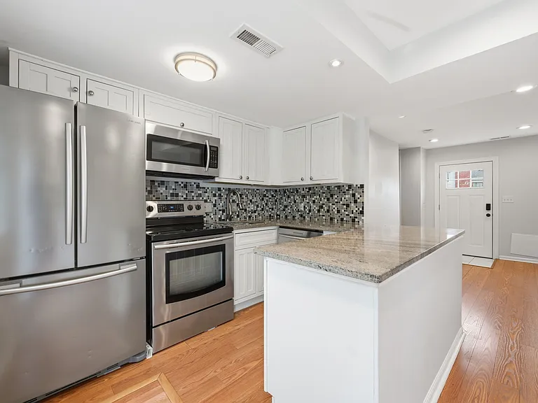Modern Kitchen with Granite Countertops, Stainless Steel Appliances, and Open Floor Plan