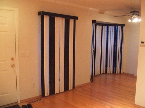 Living room and dining room with bay window, custom blinds