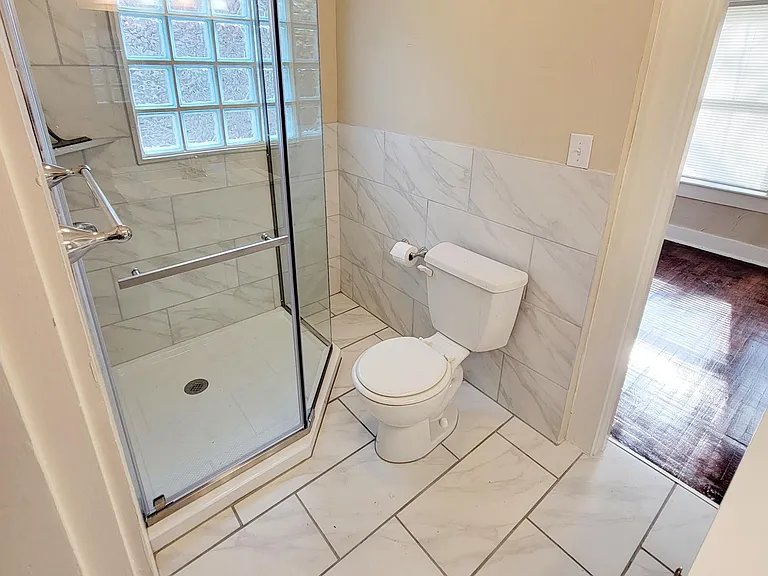 Completely remodeled Bathroom with new shower, tile and vanity. In between both bedrooms