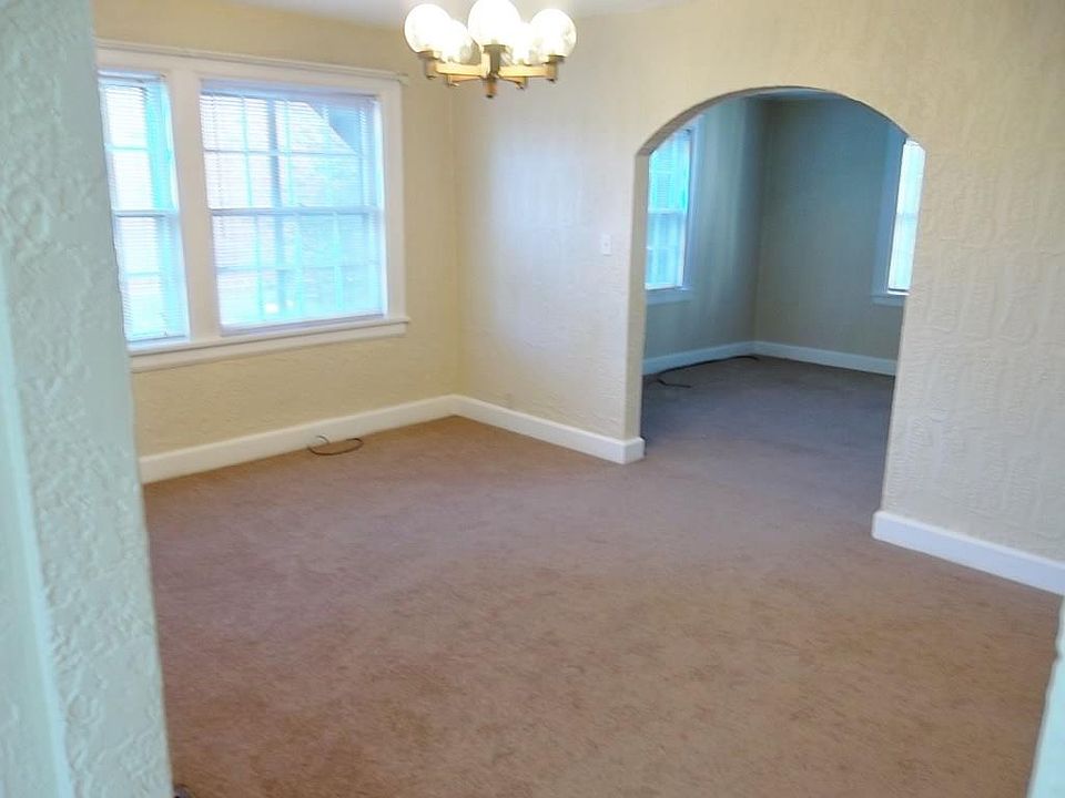 Spacious dining room with view of living room.