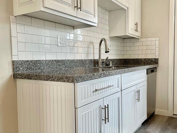 Plenty of storage in this kitchen, which includes modern fixtures and stainless steel dishwasher.