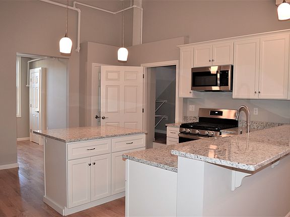 Kitchen opening to dining room and back hall