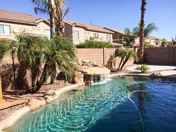 Waterfall with pool and desert landscape and mature plantings