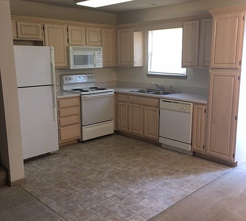 Open kitchen includes stove, fridge, dishwasher, microwave and garbage disposal.