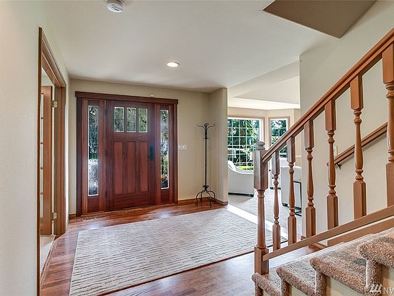 The spacious entry is light and bright and shows off the beautiful Craftsman front door and leads you to the den/office and living room.