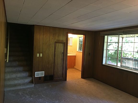 Stairs to laundry/bad weather entrance by garage and entrance to kitchen