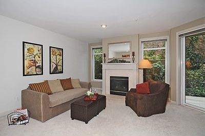 OPen living room has gas burning fireplace.