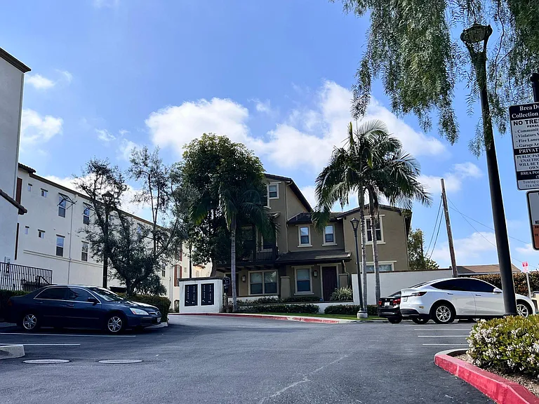 entrance of community with guest parking spots.