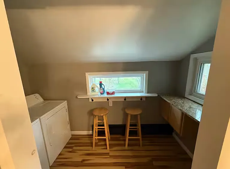 Convenient laundry area with washer/dryer and folding counter space.