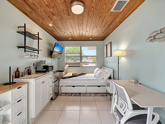 Bed, work table, kitchenette, AC, TV.