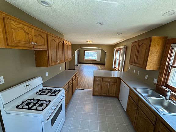 Kitchen flows into living room.