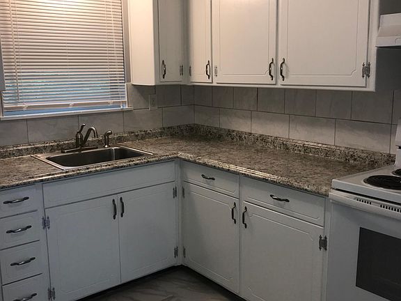 Newly painted cabinets, new countertops, new tile and backsp