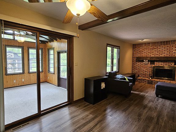 Large eating area between kitchen and TV room with fireplace