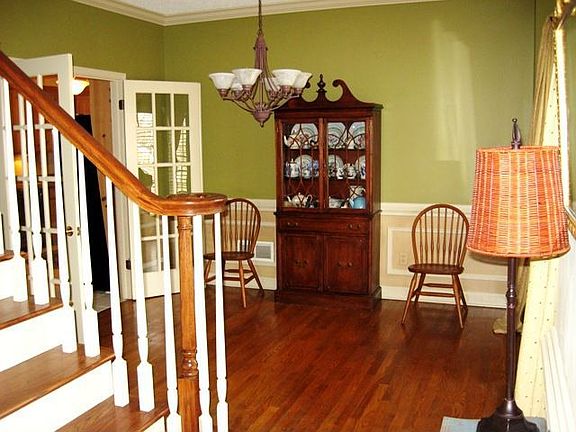 Glowing hardwoods adorn this formal dining area fit for any large party.
