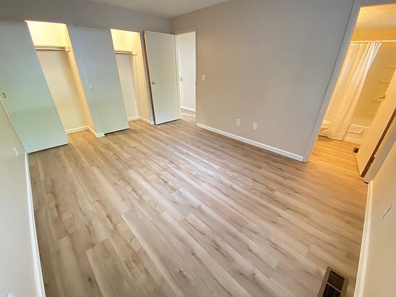 Primary bedroom with 2 closets with sliding doors and lights inside each
