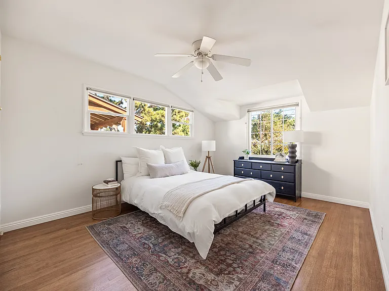 Secondary bedroom with built in closet space and dresser.