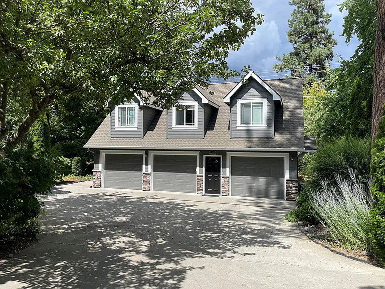 Stand-alone ADU building with apartment above and one-single car oversized garage