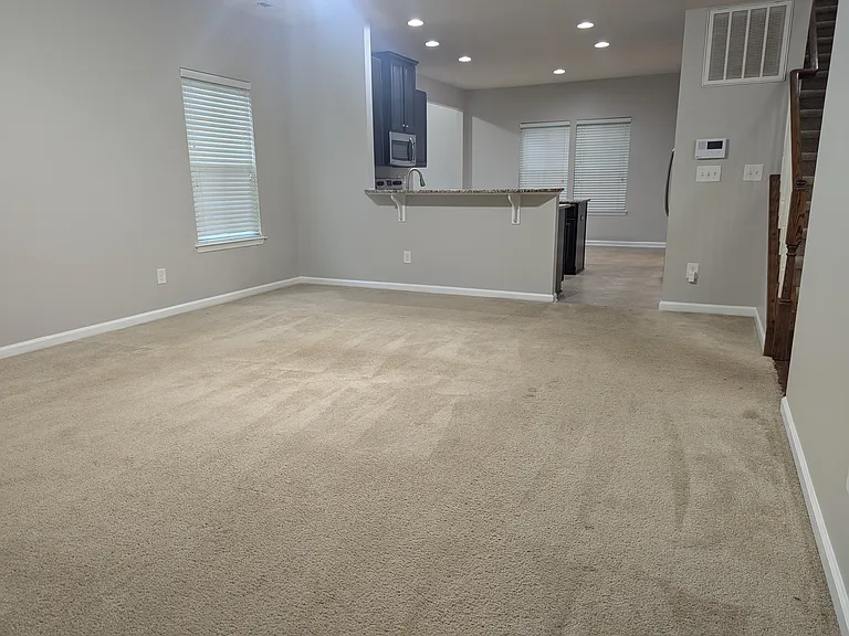 (prior to new laminate flooring) Family room looking towards the kitchen