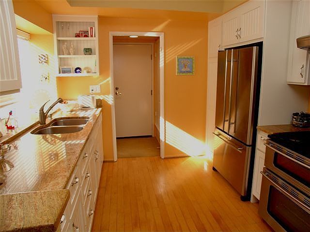 Bright kitchen with Granite and hardwood floor upgrades