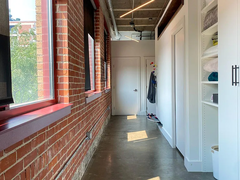 Hallway with storage and lots of windows.