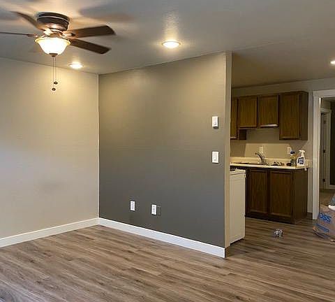 View of living room, looking into kitchen.
