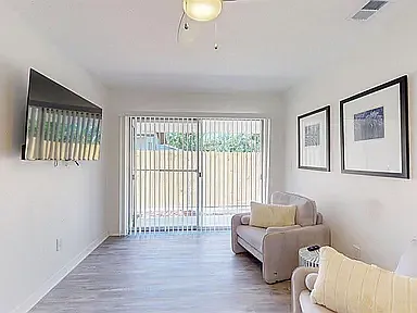 Clean, well-decorated common living space with modern finishes and open hallway to bedrooms