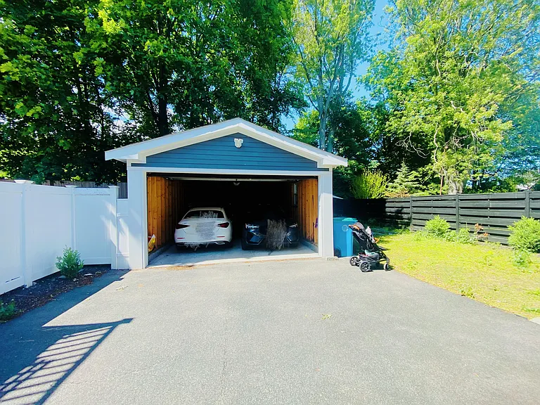 Garage shared with condo neighbor and can park one car. Additional cars can be parked on the paved drive way.