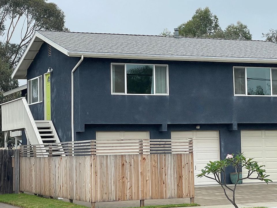 Stair to front door. Single car garage to the left and parking in front of garage.