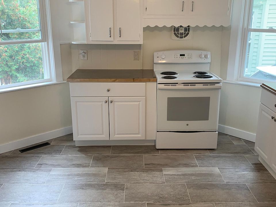 Kitchen with new paint, floors, cabinet and butcher block counter